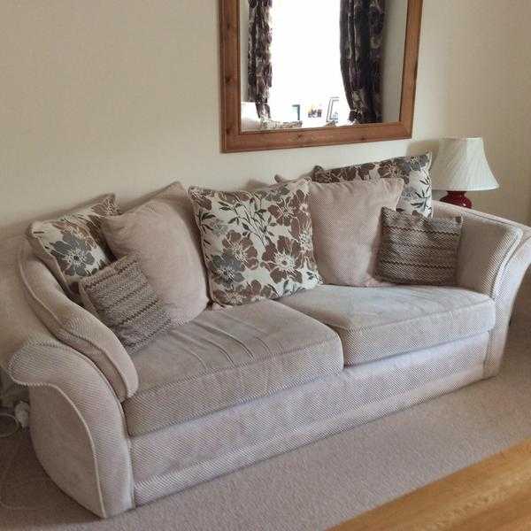 Two three seater sofas in a fawn colour material.Less than 18 months old .