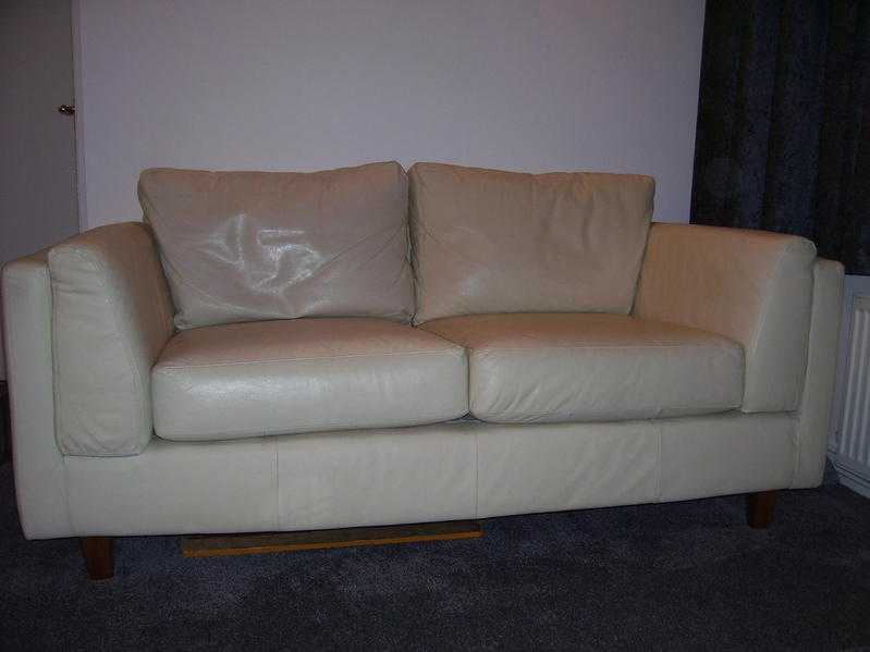 two two seater cream leather sofas.