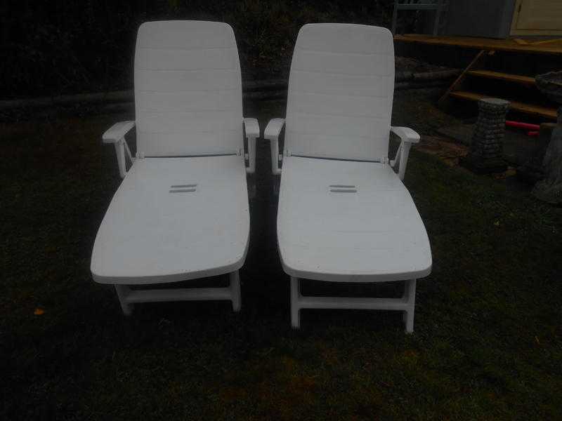 TWO WHITE PLASTIC SUN LOUNGERS