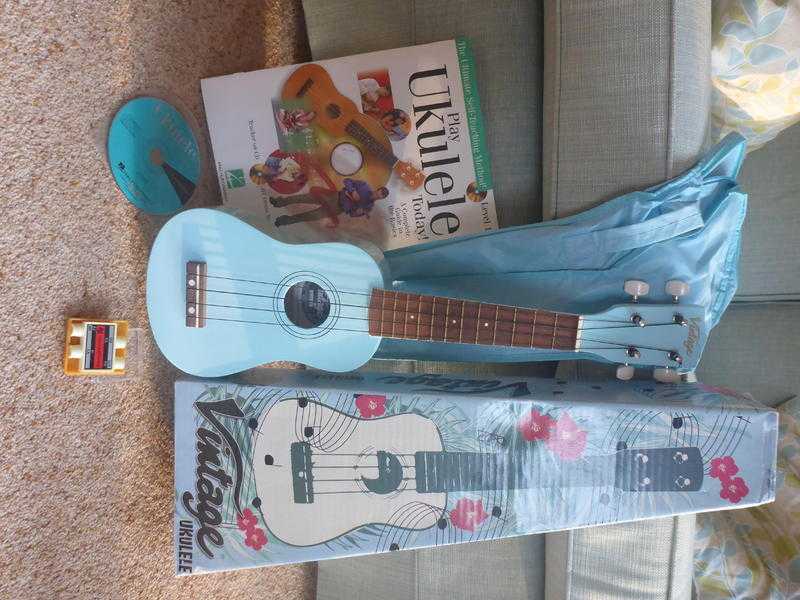 Ukelele with case, box, book with CD and pitch pipes