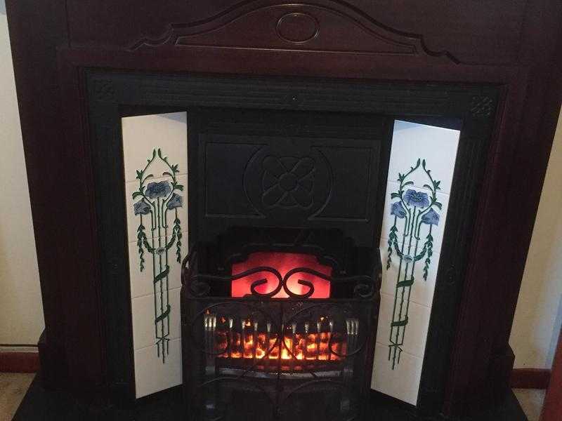 Victorian style cast iron and wood fireplace