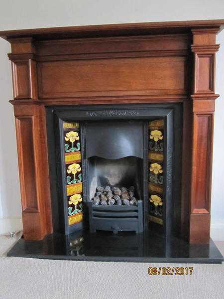 Walnut fireplace with cast iron inset