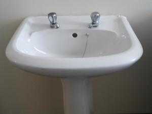 White circular sink with pedestal.