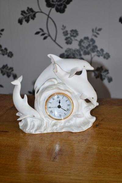 White Clock surrounded by Dolphins