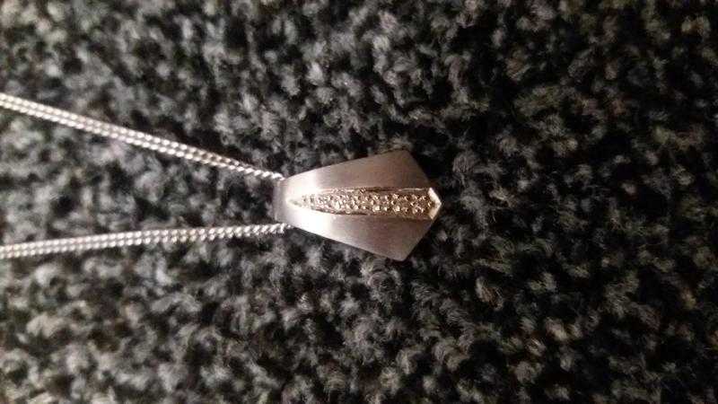 White gold and dimond pendant with silver chain