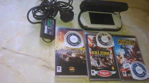 white Sony PSP with 3 games with cases and 5 downloaded games on memory card