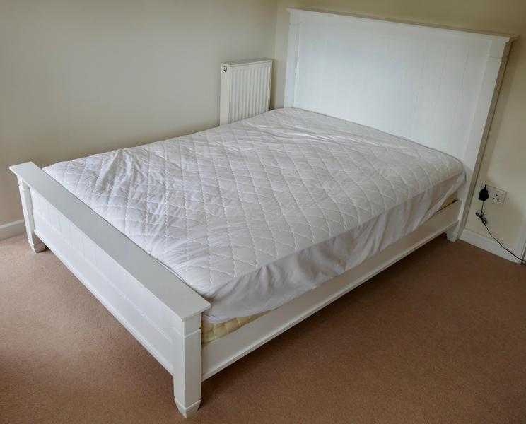 White wooden double bed.