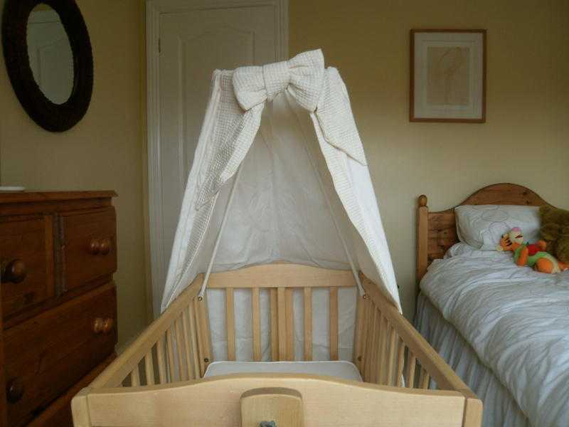 Wooden baby crib with halo canopy