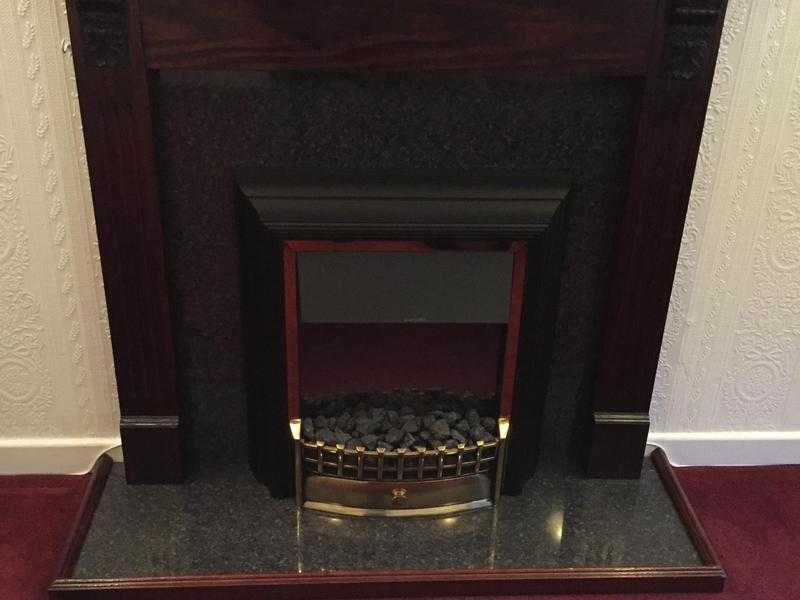 Wooden fireplace including electric fire, in Chepstow.