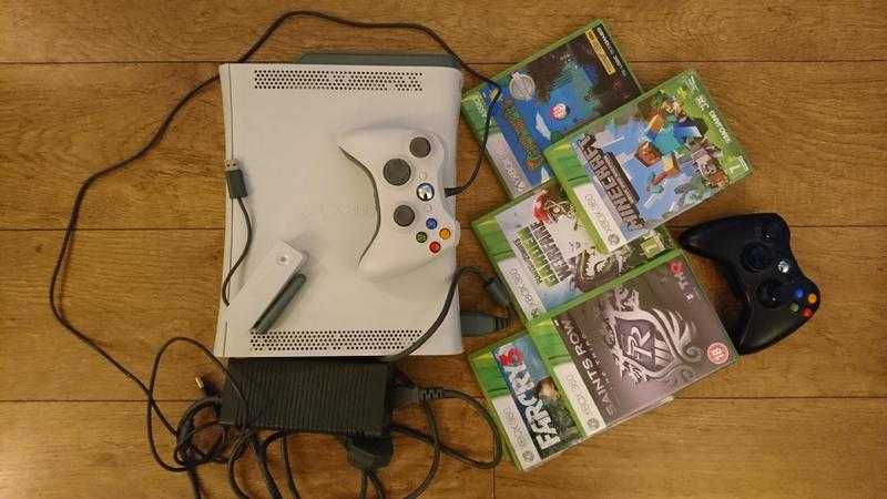 X box 360 console with a few games